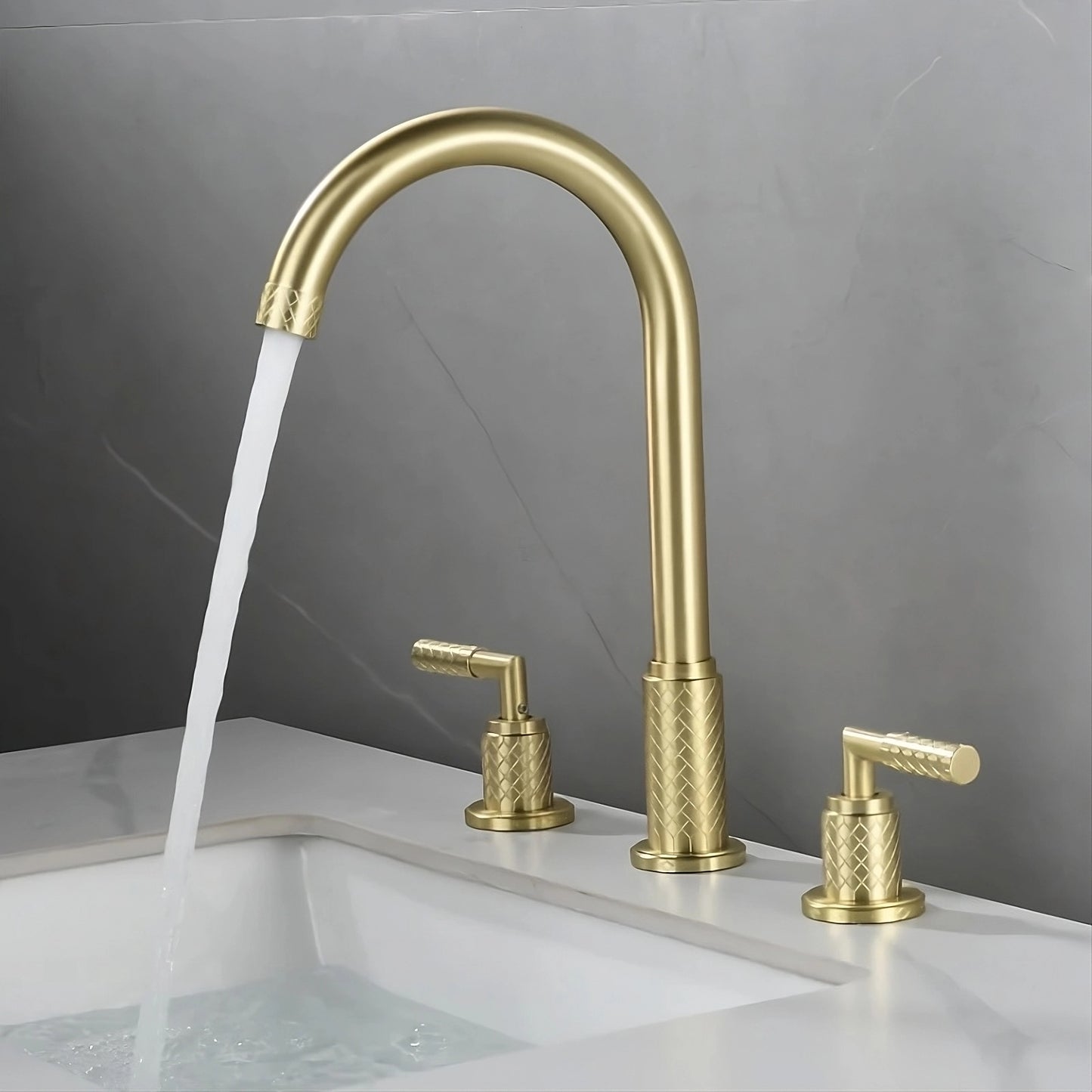 A modern bathroom sink with the Tiqui™ Solid Brass Bathroom Sink Faucet by Mike Jake, featuring a tall arched spout with running water. The faucet has textured handles for hot and cold water on either side. The rectangular sink is set into a marble countertop against a gray wall.