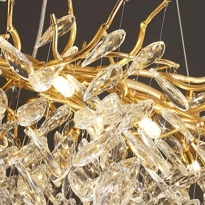 The Albero Collection Crystal Ceiling Light Fixture by Morsale.com features an ornate, gold-toned chandelier design adorned with numerous hanging crystal prisms. Its intricate structure includes branching gold elements, enhanced by dimmable LED bulbs for added versatility. This gives the chandelier an elegant and luxurious appearance as the crystals catch and reflect the light beautifully.