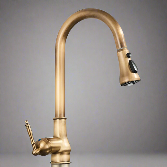 The Rozin Antique Brass Pull-Down Spout Kitchen Faucet features a tall, curved spout and single lever handle. This modern, deck-mounted fixture is shown against a plain gray background.