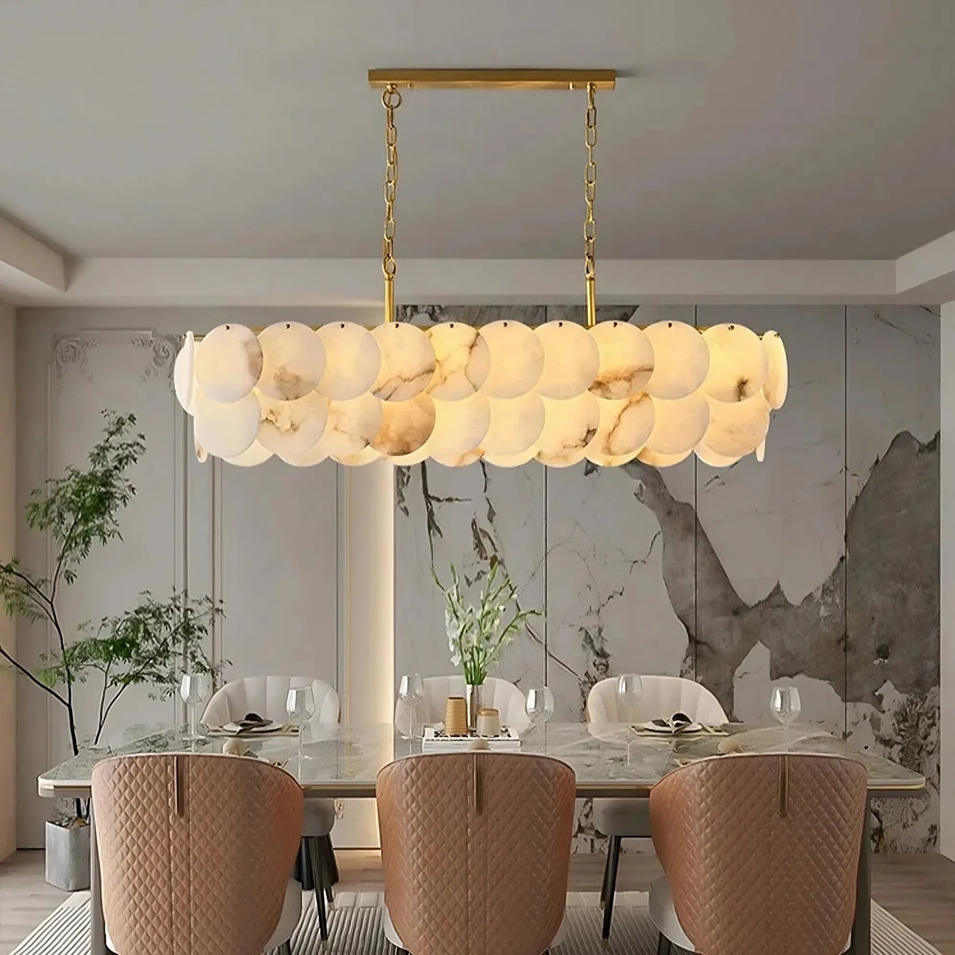 Moonshade Marble Dining Room Chandelier emitting soft warm light over an elegant dining table.