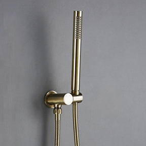 A modern bathroom featuring the Wasser™ Solid Brass Complete Shower System from Morsale.com, with a sleek rainfall showerhead mounted on a gray wall and a matching handheld shower faucet attached. Water cascades down as the shower is turned on. The room showcases a minimalist design with a white sink and a stone accent wall in the background.