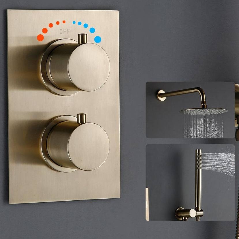 Wasser™ Brushed Gold Thermostatic Shower System from Morsale.com offers a contemporary shower setup with a sophisticated, matte-finish wall-mounted control panel that features two round knobs, one labeled "OFF." A nearby handheld showerhead emits water in a fine mist. The fixtures, including the coordinating bathroom sink faucet and brushed gold shower faucet, elegantly complement the dark gray background.