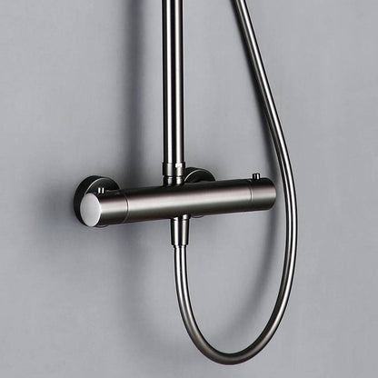 The Wasser™ Gunmetal Grey Shower Faucet With Handheld Spray by Morsale.com is a sleek, modern shower system featuring a round overhead showerhead and a detachable handheld spray wand. The showerhead releases a stream of water, set against a light gray background. With its brushed metal finish, this fixture offers a minimalist aesthetic reminiscent of high-end bathroom faucets.