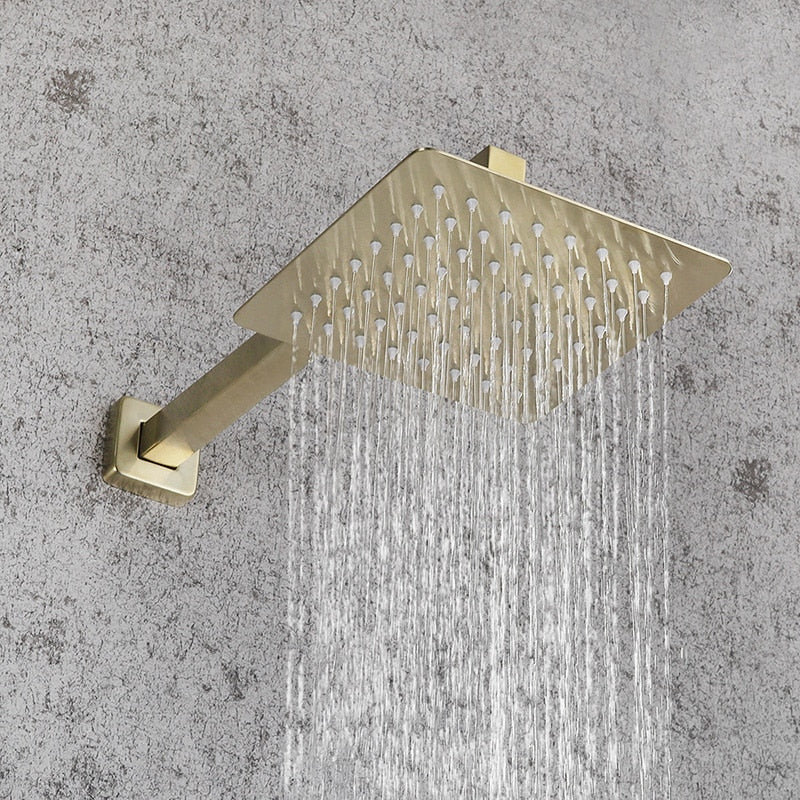 A modern bathroom features AllFixture's Wall Mounted Complete Shower Set With Handheld Sprayer in a sleek, gold-tone. The shower fixtures are mounted against a white wall, complemented by a stylish bathroom sink faucet nearby. A framed picture with green and yellow abstract art is visible near a clear glass shower screen.