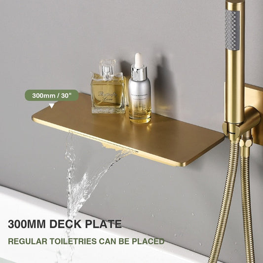 A Wasser™ Waterfall Bathroom Faucet with Handheld Shower Set by AllFixture, finished in modern gold, is mounted on a gray wall. The fixture includes an integrated shelf holding a few small bottles and features a control panel with two knobs, exemplifying the elegance of premium bathroom faucets. Below, a filled bathtub is visible.