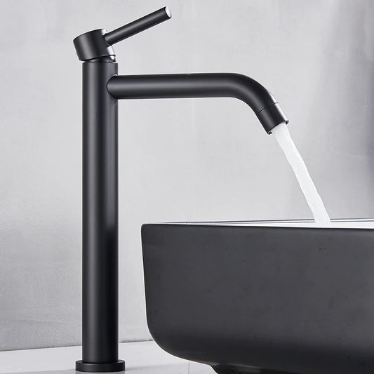 A stylish, contemporary black Single Handle Deck Mounted Bathroom Sink Faucet by Rozin is installed on a countertop. Water streams into a coordinating rectangular black sink below it. The minimalist design showcases a matte finish on both the faucet and sink.