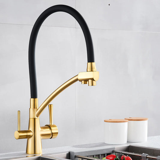 Over a stainless steel sink, the Solid Brass Kitchen Faucet With Purified Water Tap from allfixture takes center stage with its sleek, gold finish and flexible black hose. The background boasts a grey backsplash and two white canisters with wooden lids on the countertop, echoing the elegance of premium bathroom faucets.