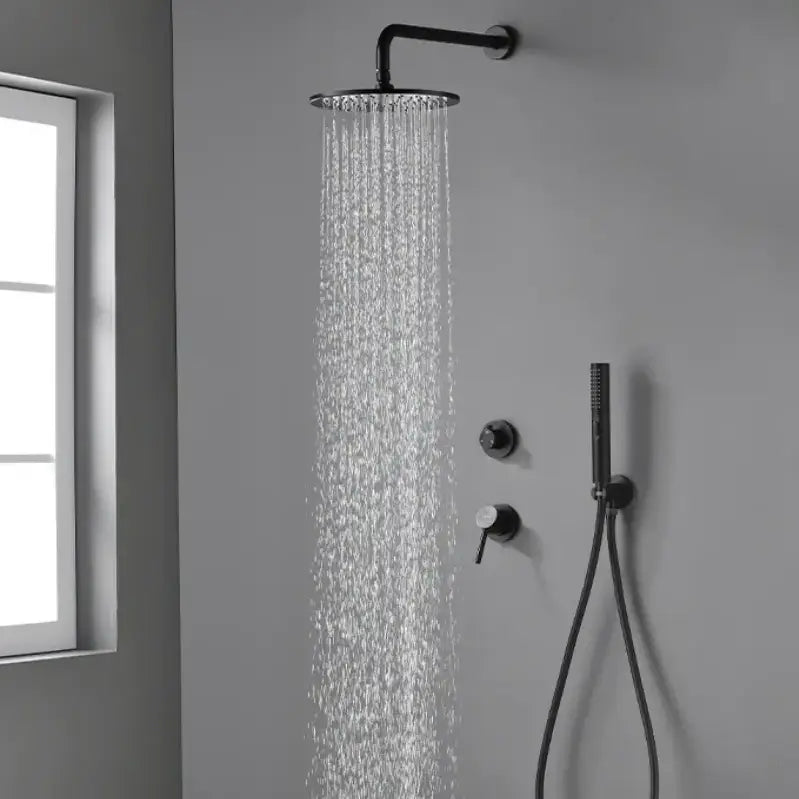 A modern shower set-up featuring the Wasser™ Solid Brass Shower Faucet With Bathtub Faucet from allfixture, in a sophisticated matte black finish against a gray wall. The setup includes a round overhead rain shower head, three control knobs, a wall-mounted handheld shower with a hose, and an additional small wall-mounted fixture likely for a towel or bathrobe. Complete the look with an elegant bathroom sink faucet for sleek coordination.