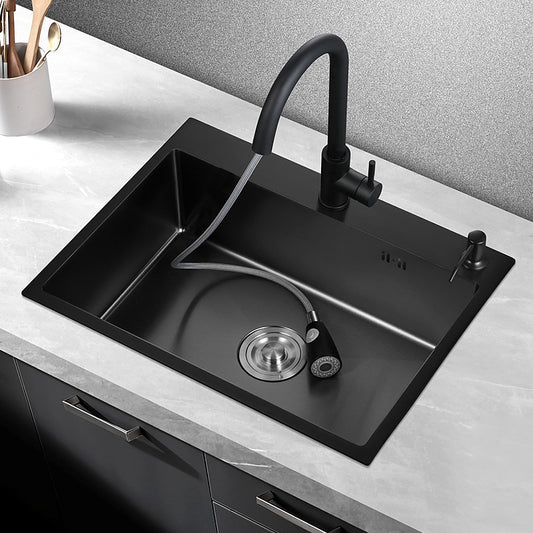 A sleek black 304 Stainless Steel Single Bowl Kitchen Sink with a matching black faucet from AllFixture is installed in a marble countertop. The faucet, reminiscent of a stylish bathroom sink faucet, has a pull-out sprayer extending into the sink. Nearby, a set of cooking utensils is kept in a white container. The sink area is clean and modern.