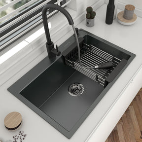 A sleek black 304 Stainless Steel Single Bowl Kitchen Sink with a matching black faucet from AllFixture is installed in a marble countertop. The faucet, reminiscent of a stylish bathroom sink faucet, has a pull-out sprayer extending into the sink. Nearby, a set of cooking utensils is kept in a white container. The sink area is clean and modern.