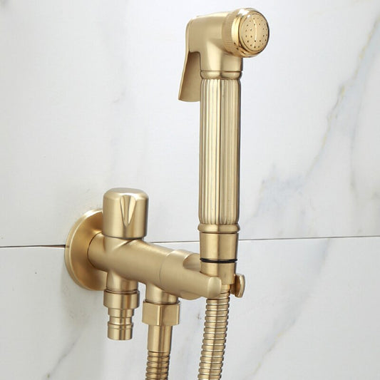 An elegant **Wall-Mounted Brass Handheld Sprayer** by **AllFixture**, featuring a sleek minimalist design with vertical lines for grip, is installed against a white marble background. The modern gold-colored set includes a handheld shower head and hose, creating a stylish addition to the bathroom.