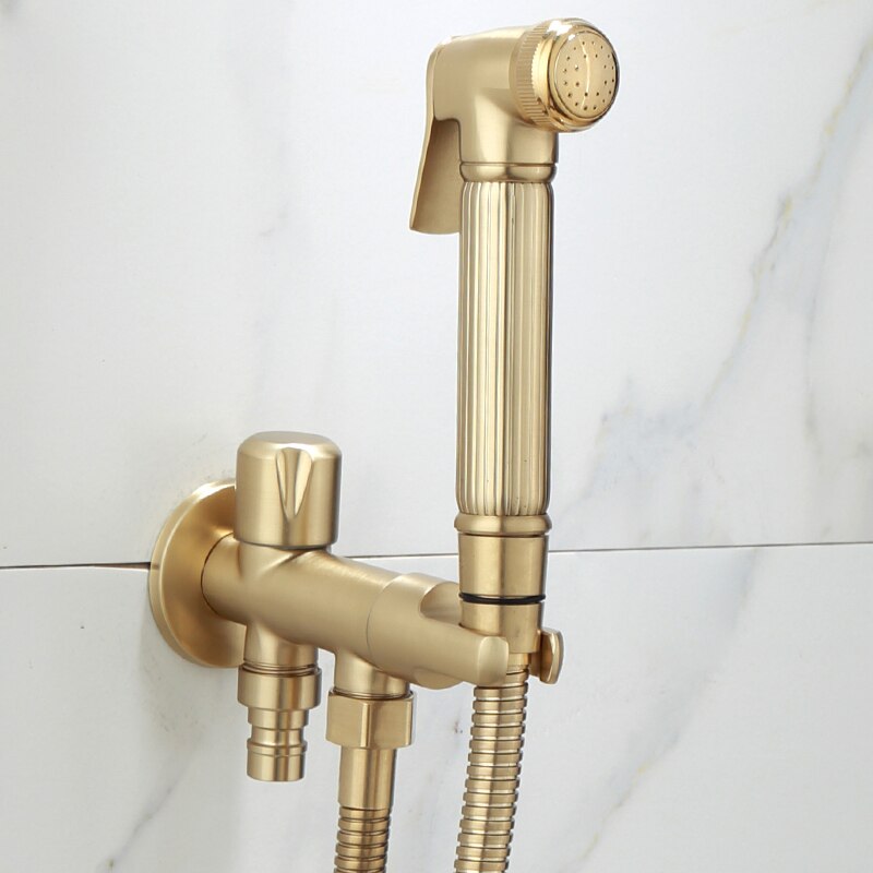 An elegant **Wall-Mounted Brass Handheld Sprayer** by **AllFixture**, featuring a sleek minimalist design with vertical lines for grip, is installed against a white marble background. The modern gold-colored set includes a handheld shower head and hose, creating a stylish addition to the bathroom.