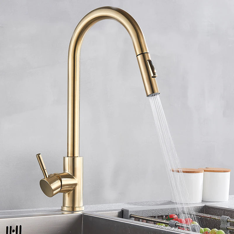 The allfixture Stainless Steel Smart Touch Pull Out Kitchen Faucet, featuring a high arch spout and a pull-down spray head, is mounted on a sleek stainless steel sink, dispensing a stream of water. Flanked by two white containers with wooden lids against a muted gray background, it creates an elegant and functional kitchen space.