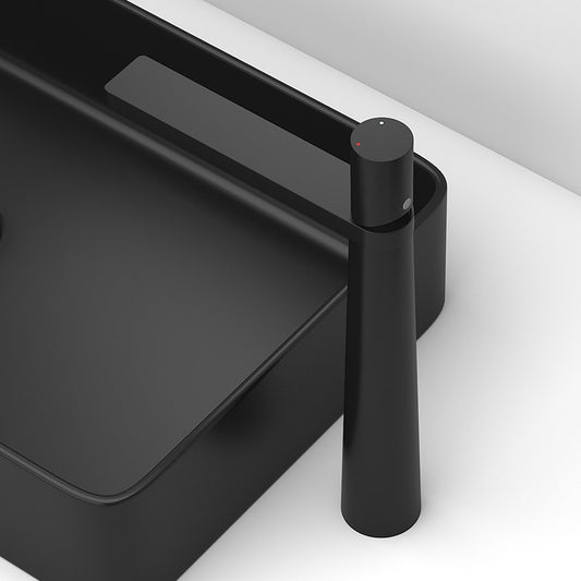 A sleek, modern Single Handle Matt Black Bathroom Faucet by Tiqui sits adjacent to a black rectangular sink with a minimalist design. The setup is against a white background, emphasizing the contrast and contemporary aesthetic.