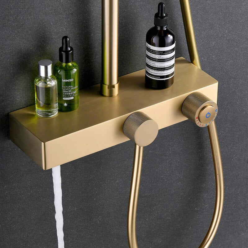 Image of a modern shower setup with a sleek black wall background. The shower features the Complete Shower Set With Handheld Sprayer by Mike Jake, showcasing a rainfall showerhead, a handheld sprayer, and a small shelf holding various toiletries. Water cascades down from the rainfall showerhead, seamlessly complementing the nearby bathroom faucets.