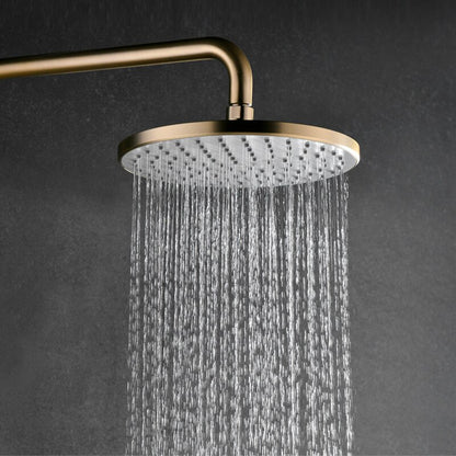 Image of a modern shower setup with a sleek black wall background. The shower features the Complete Shower Set With Handheld Sprayer by Mike Jake, showcasing a rainfall showerhead, a handheld sprayer, and a small shelf holding various toiletries. Water cascades down from the rainfall showerhead, seamlessly complementing the nearby bathroom faucets.