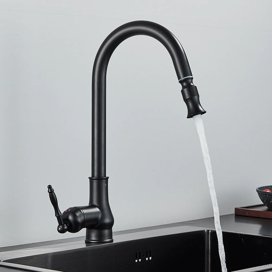 A Rozin Matte Black Pull-Down Kitchen Faucet with a high-arched spout is turned on, releasing water into a stainless steel sink set against a plain gray background.