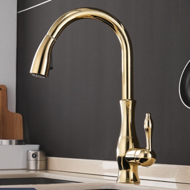 A sleek, modern Wanfan Multitask Pull Out Spout Kitchen Faucet with a curved design and single lever handle is mounted on the countertop. The background features a dark-colored backsplash and a wooden cutting board partially visible on the left, creating an elegant contrast reminiscent of high-end bathroom faucets.