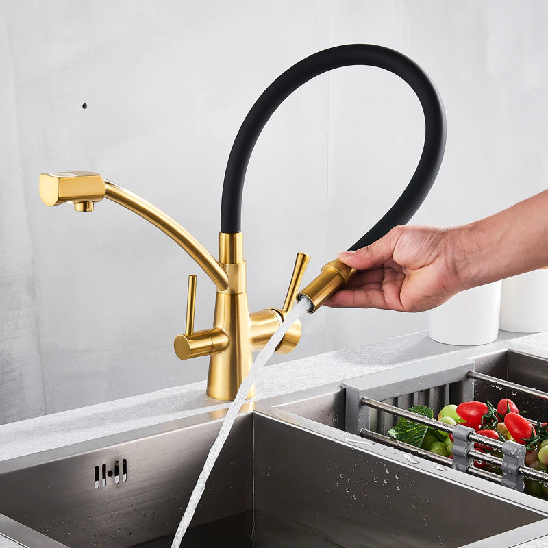 Over a stainless steel sink, the Solid Brass Kitchen Faucet With Purified Water Tap from allfixture takes center stage with its sleek, gold finish and flexible black hose. The background boasts a grey backsplash and two white canisters with wooden lids on the countertop, echoing the elegance of premium bathroom faucets.