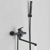 The Wall Mounted Bathtub Shower Faucet With Handheld Shower by Rozin is a sleek, modern fixture. It features a matte black finish, a single lever handle, and a detachable hand shower with a slim, cylindrical design. The faucet itself has a swiveling spout, and the hand shower is conveniently mounted on the wall above it.