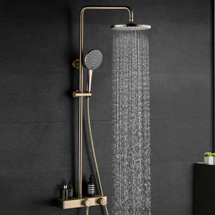 Image of a modern shower setup with a sleek black wall background. The shower features the Complete Shower Set With Handheld Sprayer by Mike Jake, showcasing a rainfall showerhead, a handheld sprayer, and a small shelf holding various toiletries. Water cascades down from the rainfall showerhead, seamlessly complementing the nearby bathroom faucets.