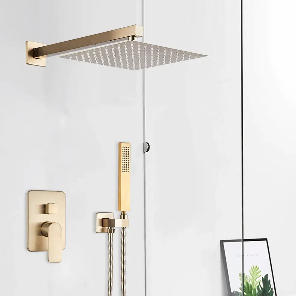 A modern bathroom features AllFixture's Wall Mounted Complete Shower Set With Handheld Sprayer in a sleek, gold-tone. The shower fixtures are mounted against a white wall, complemented by a stylish bathroom sink faucet nearby. A framed picture with green and yellow abstract art is visible near a clear glass shower screen.